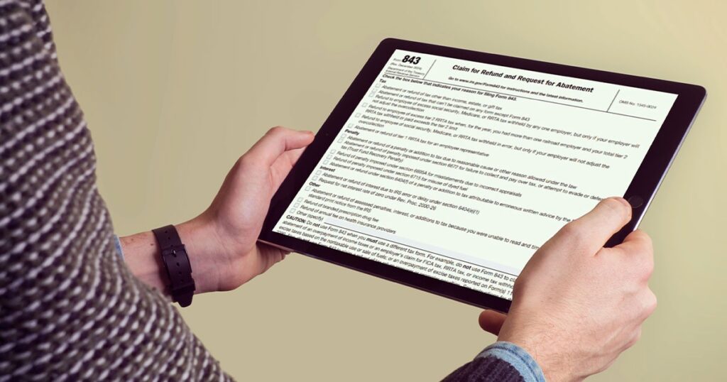 A person holding a tablet displaying a form titled "What Is Form 843 and When Should You Use It?