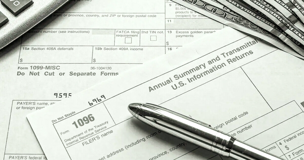 A close-up of Form 1096 alongside cash, illustrating the relationship between taxes and personal finance.