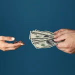 Hands exchanging cash, representing a financial transaction