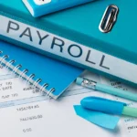 Payroll folder with financial documents and calculator