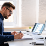 Business owner using bookkeeping software at a modern desk for small business accounting in 2026.