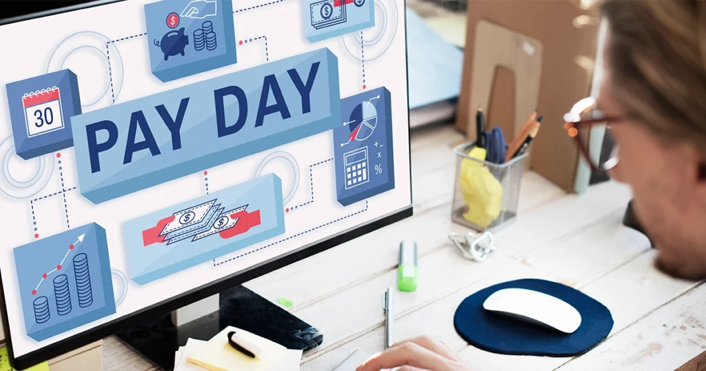 Person managing the accounts payable process on a computer displaying payday graphics.