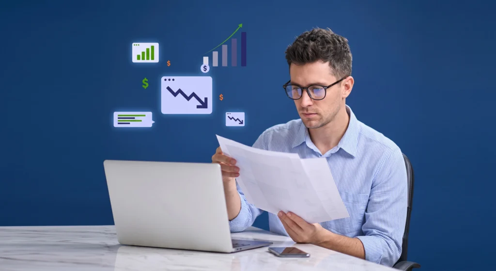 A Man reviewing financial reports at his desk with growth and decline metric icons floating nearby.